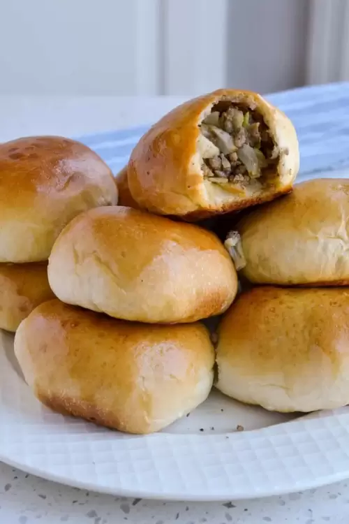 A runza is a golden dough wrapped pocket filled with ground beef, onions, and cabbage.