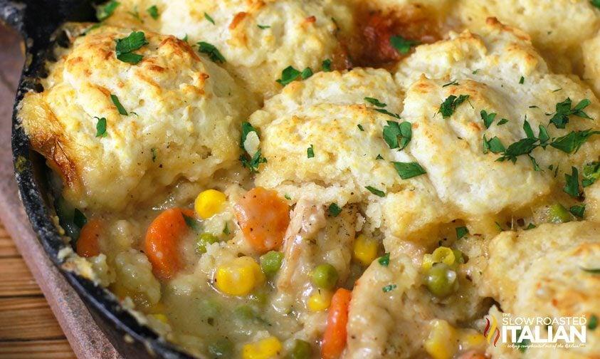 chicken pot pie with biscuit topping in cast iron skillet