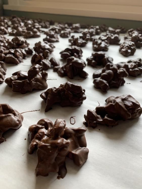 Chocolate nut clusters on white parchment paper